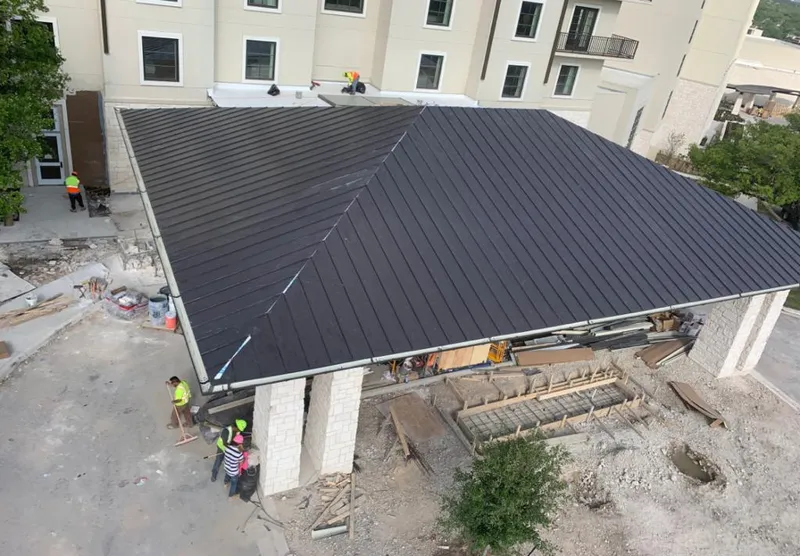 Metal roofing installation team working on a commercial building in Las Vegas